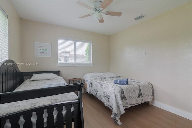 bedroom with ceiling fan and hardwood / wood-style floors