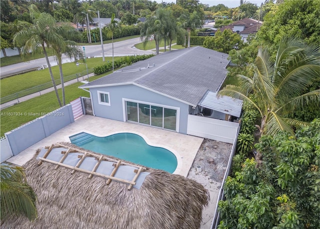 view of swimming pool with a yard and a patio area