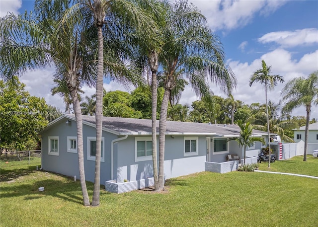 rear view of property featuring a yard