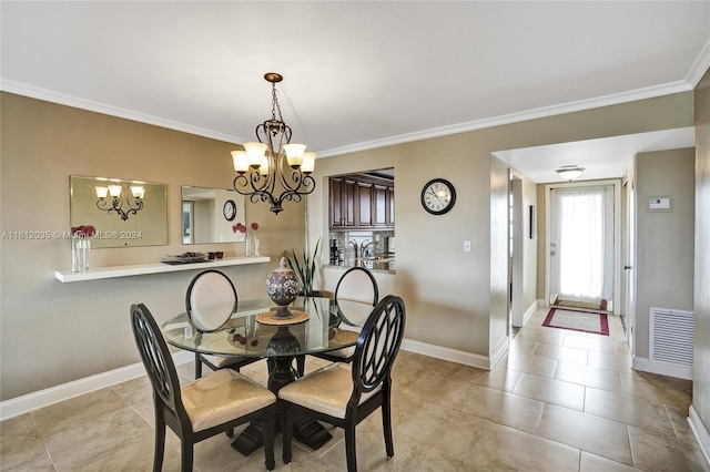 dining room with an inviting chandelier, crown molding, and light tile floors