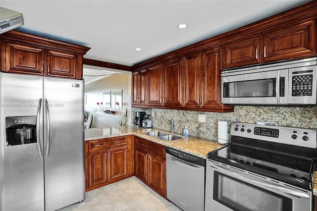 kitchen with light stone counters, sink, light tile floors, and appliances with stainless steel finishes