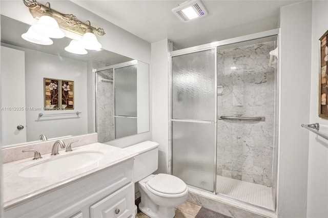 bathroom featuring a shower with shower door, tile flooring, vanity, and toilet