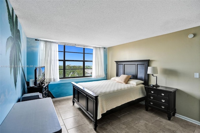 bedroom featuring tile floors and a textured ceiling