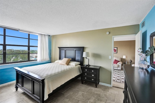 tiled bedroom with a textured ceiling