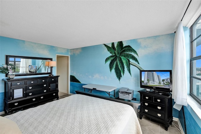 bedroom with a textured ceiling and light tile flooring