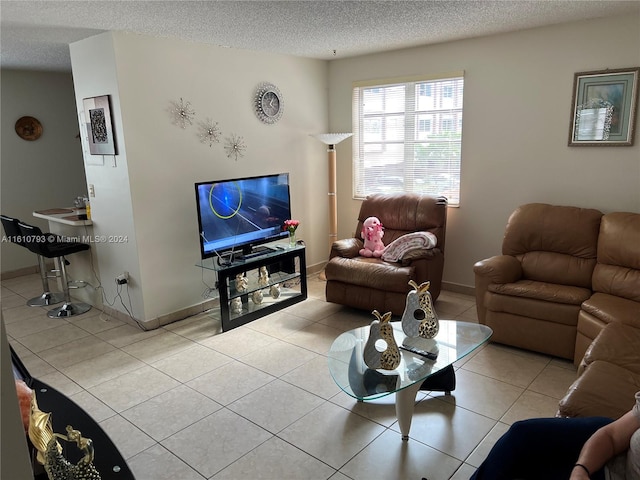 tiled living room featuring a textured ceiling