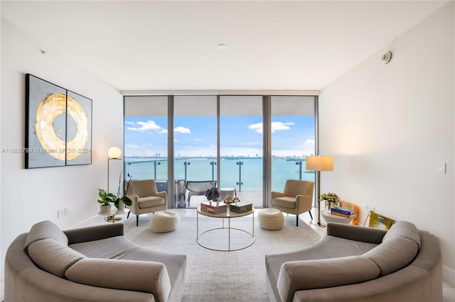 living room featuring a water view and floor to ceiling windows