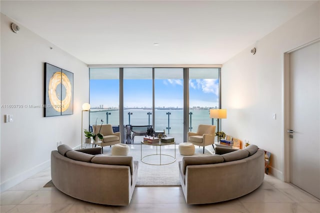 living room with a water view and a wall of windows