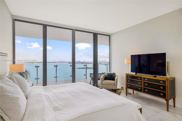 bedroom featuring access to outside and a wall of windows