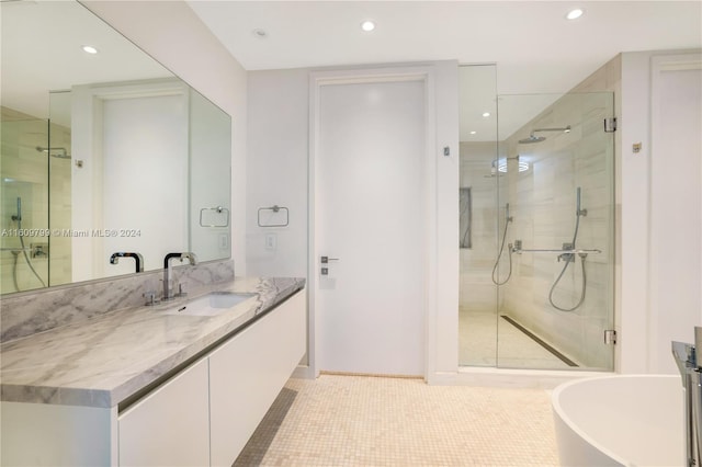 bathroom with tile patterned flooring, vanity, and separate shower and tub