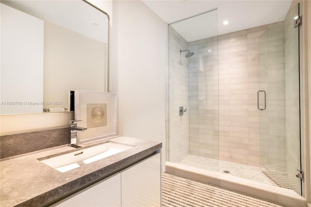 bathroom with vanity and a shower with shower door