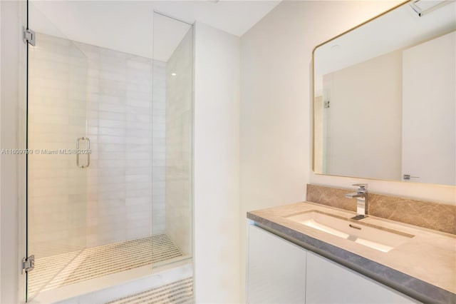 bathroom with vanity and a shower with shower door