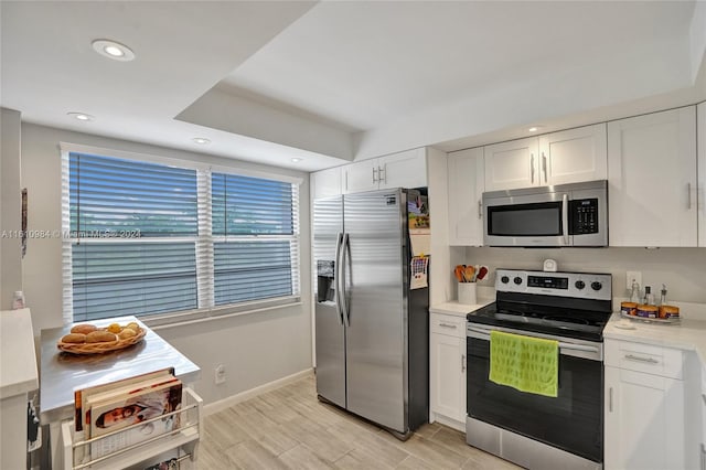 kitchen featuring white cabinetry, stainless steel appliances, and light hardwood / wood-style floors