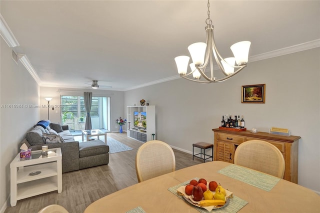 dining area featuring wood-type flooring and crown molding