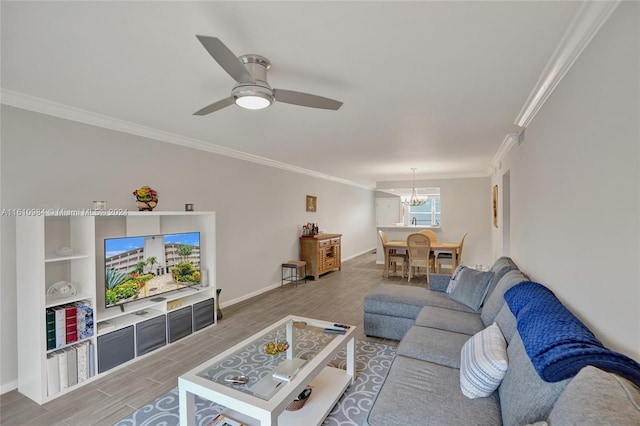 living room featuring ceiling fan with notable chandelier, crown molding, and hardwood / wood-style floors