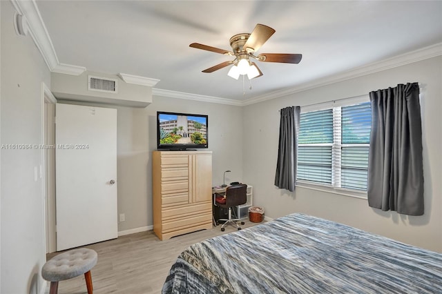 bedroom with crown molding, ceiling fan, and hardwood / wood-style floors