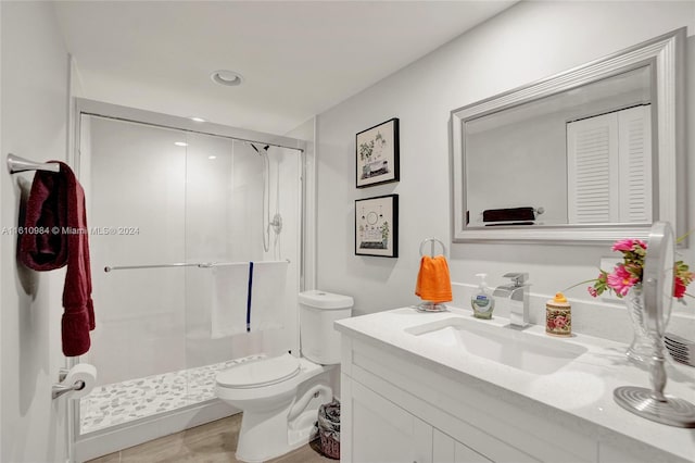 bathroom with walk in shower, tile patterned floors, toilet, and vanity