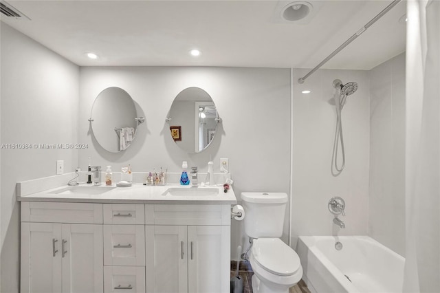 full bathroom with tiled shower / bath combo, toilet, and double sink vanity