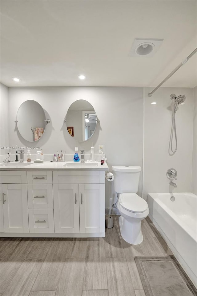 full bathroom featuring shower / bathtub combination, toilet, wood-type flooring, and double vanity