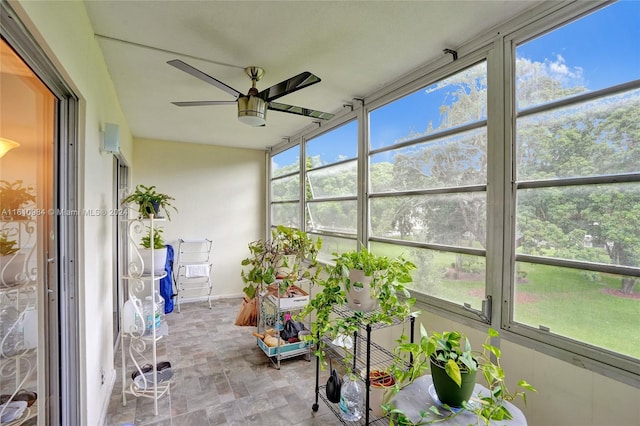 unfurnished sunroom featuring plenty of natural light and ceiling fan