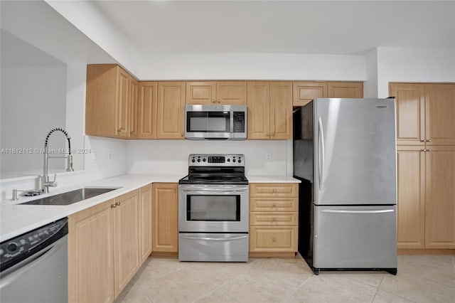 kitchen featuring light brown cabinets, sink, stainless steel appliances, and light tile patterned flooring