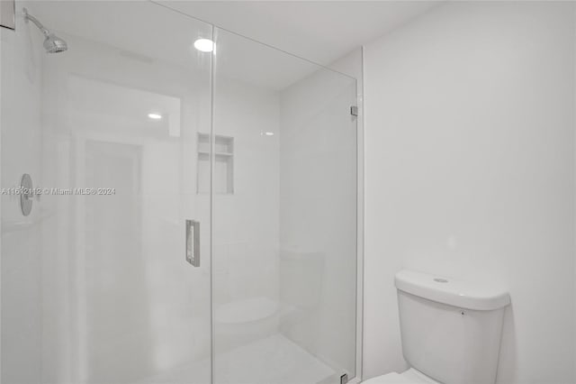 bathroom with toilet and walk in shower