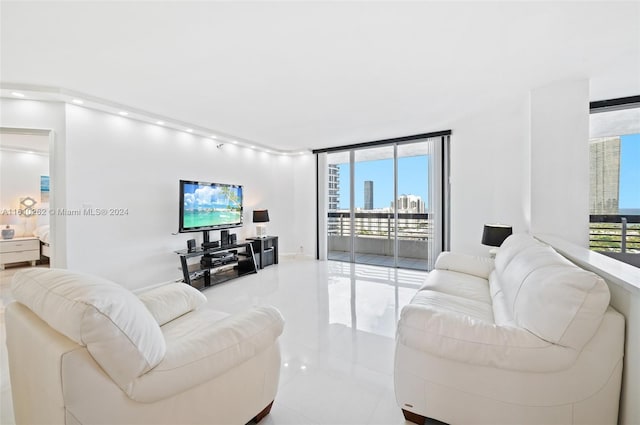 tiled living room featuring a wall of windows