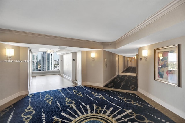 corridor featuring tile floors, ornamental molding, and a wealth of natural light