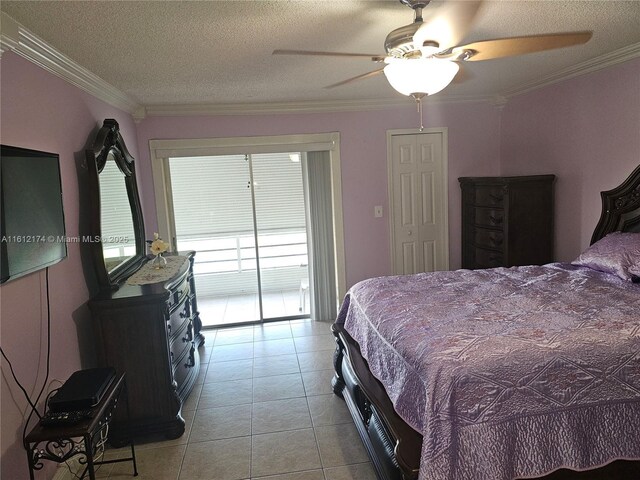 tiled dining area with a textured ceiling and crown molding