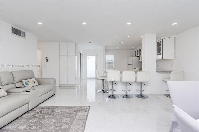 living room featuring light tile floors