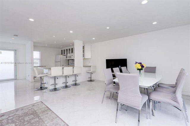 dining area featuring light tile floors