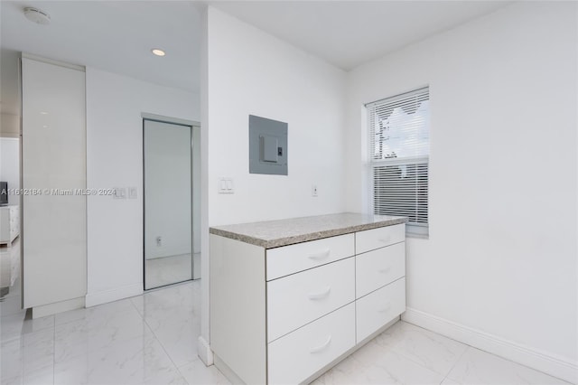 kitchen with white cabinets and light tile floors