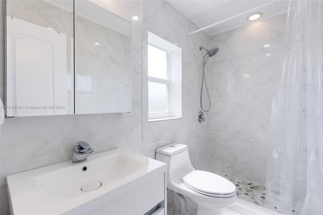 bathroom featuring a shower with curtain, tile walls, toilet, and large vanity