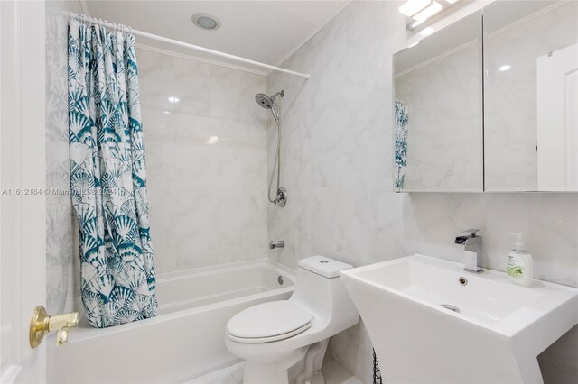 full bathroom with tile walls, sink, shower / tub combo with curtain, and toilet