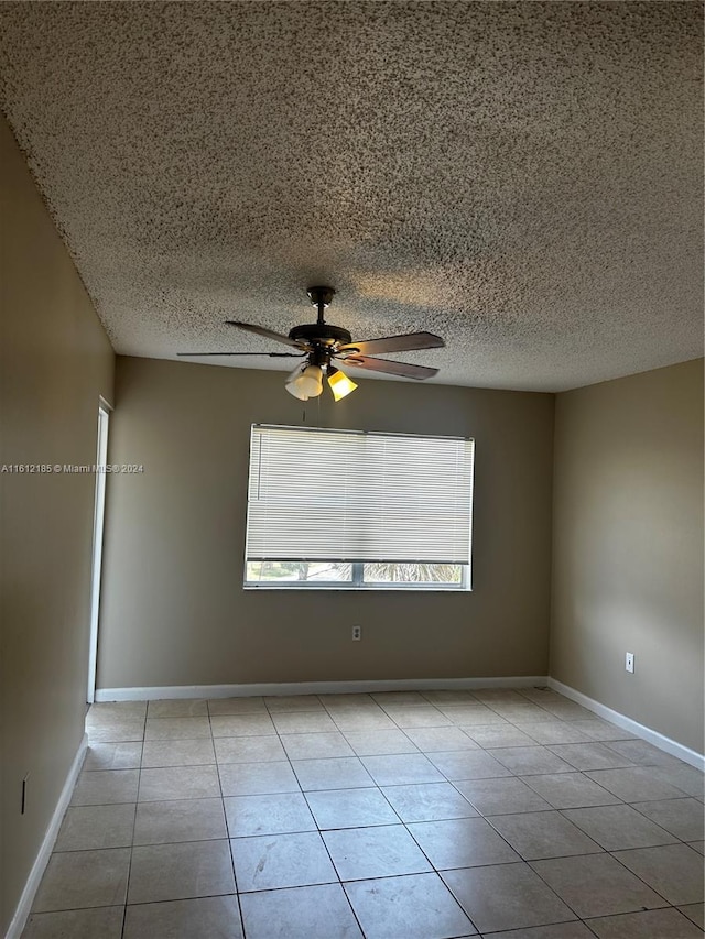 empty room featuring ceiling fan and light tile patterned flooring