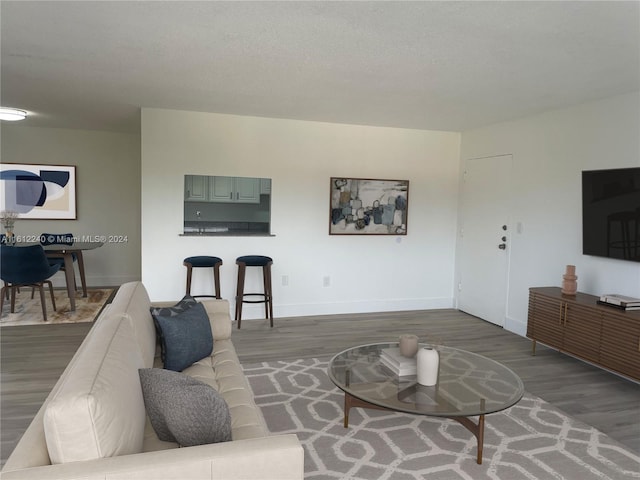 living room with dark hardwood / wood-style flooring and a textured ceiling