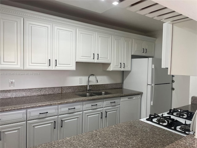 kitchen featuring dishwasher, white cabinetry, white refrigerator, and sink