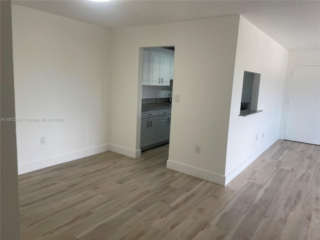 empty room featuring light hardwood / wood-style flooring and a textured ceiling