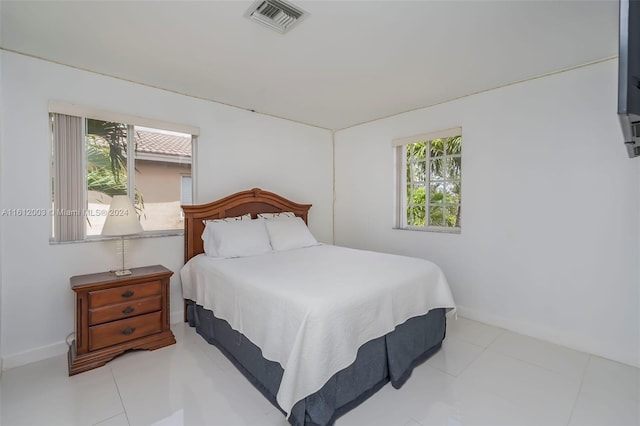 tiled bedroom with multiple windows