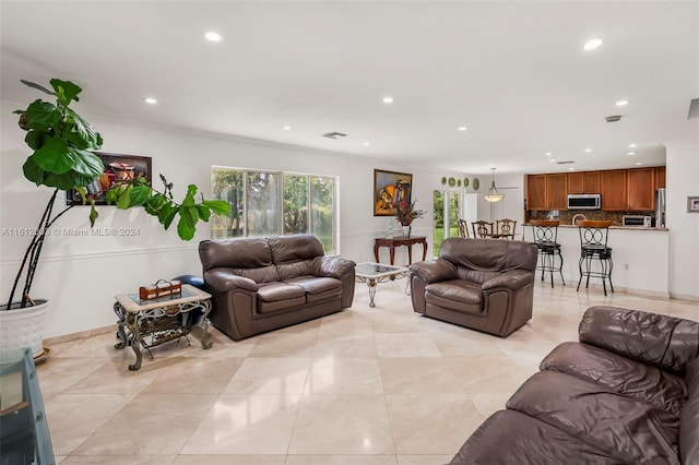 tiled living room featuring crown molding