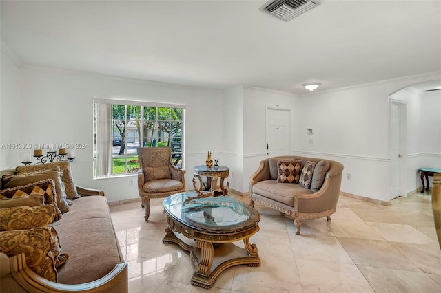 living area featuring light tile patterned floors and crown molding