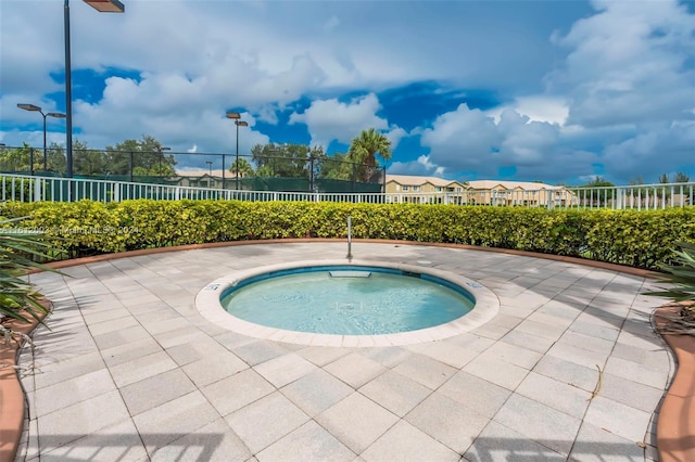 view of swimming pool featuring an in ground hot tub and a patio area