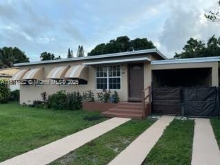 260 NW 119th St, Miami, FL 33168 - view of front of property with a front yard and stucco siding