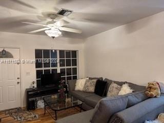 living room featuring ceiling fan and hardwood / wood-style floors