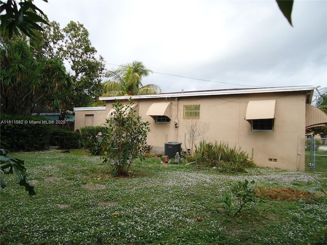 260 NW 119th St, Miami, FL 33168 - exterior space featuring stucco siding, a yard, and cooling unit
