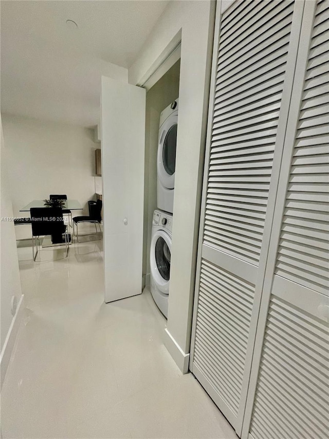 washroom featuring stacked washer / dryer