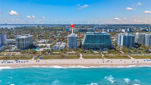 aerial view featuring a beach view, a water view, and a city view
