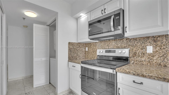 kitchen with light stone counters, stainless steel appliances, marble finish floor, backsplash, and white cabinetry