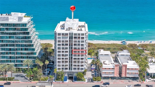 aerial view with a water view and a beach view