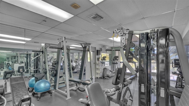 gym with a paneled ceiling